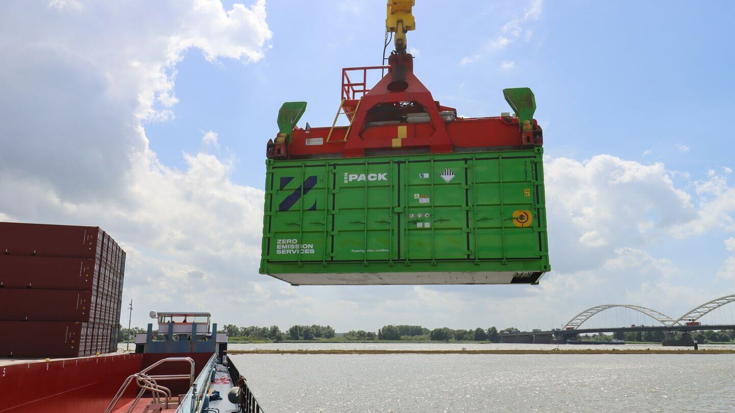 Photo of container being lifted into a barge.