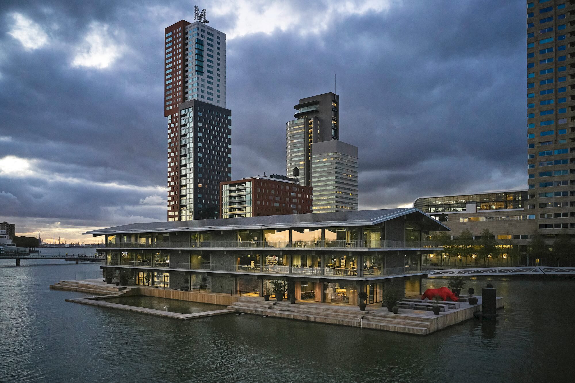 Photo: Nighttime view of Floating Office Rotterdam with part of the highrise skyline in the background. Photo: Mark Seelen